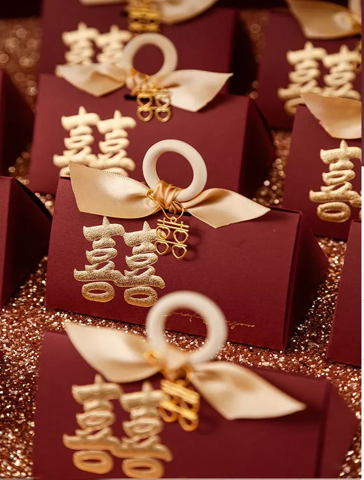 Red Luxury Gold Foil Double Happiness Favor Boxes gift boxes with gold ribbons and Chinese characters on a glittery background