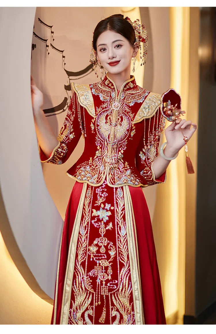 Woman in a traditional red and gold Chinese Velvet Wedding Qun Kwa Dress   with intricate patterns, holding fans.