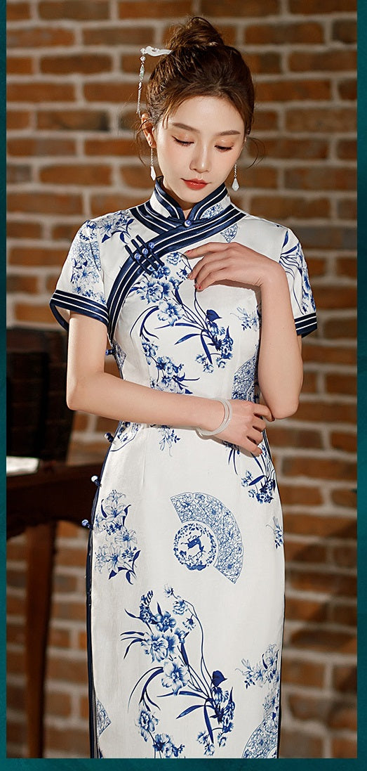 Model in Blue white floral qipao dress standing looking down
