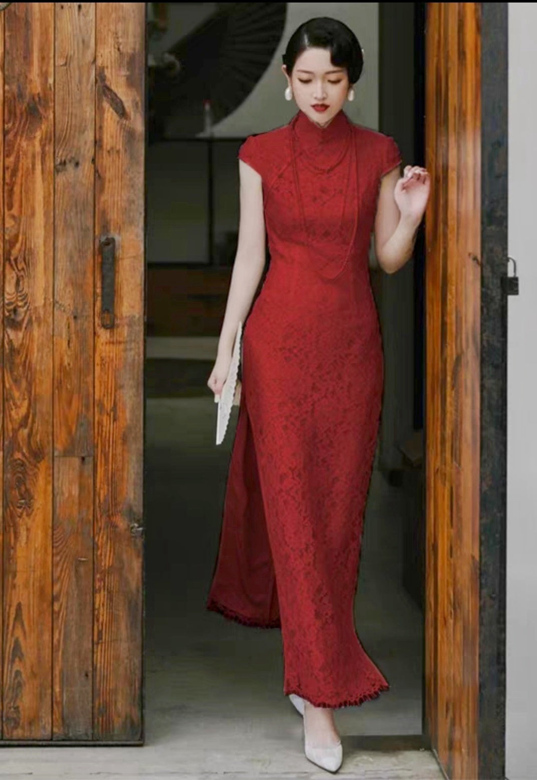 model in traditional chinese red lace cheongsam qipao walking