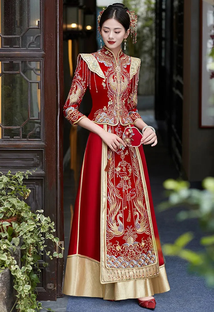 Woman in a traditional red and gold Chinese Velvet Wedding Qun Kwa Dress   standing outdoors.