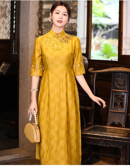 Model in loose yellow floral qipao cheongsam dress looking straight