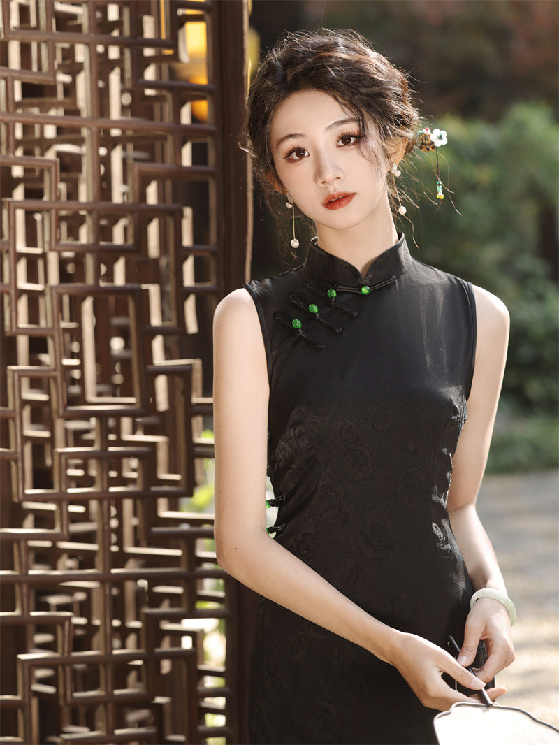 Model in black sleeveless qipao cheongsam dress looking straight