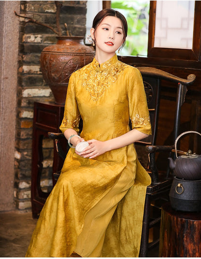 Model in loose yellow floral qipao cheongsam dress sitting