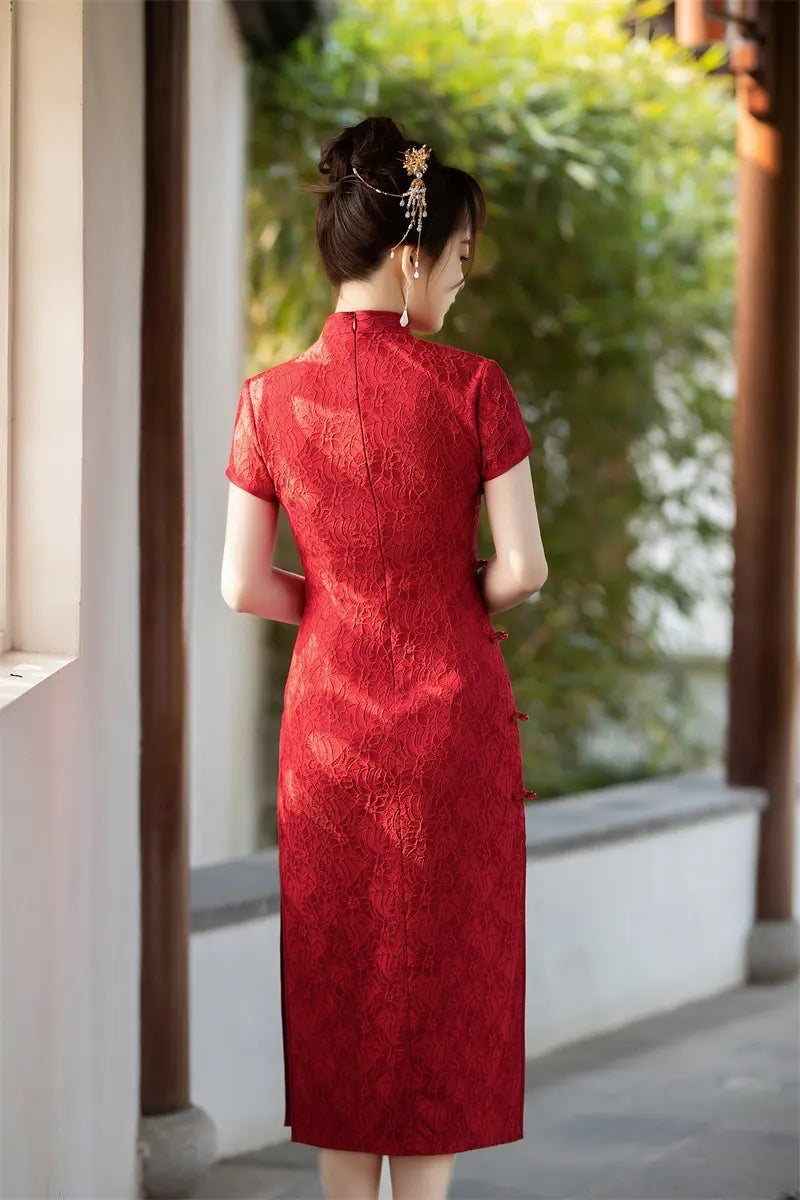 Woman in a red traditional chinese Auspicious Red Lace Qipao standing in a garden setting