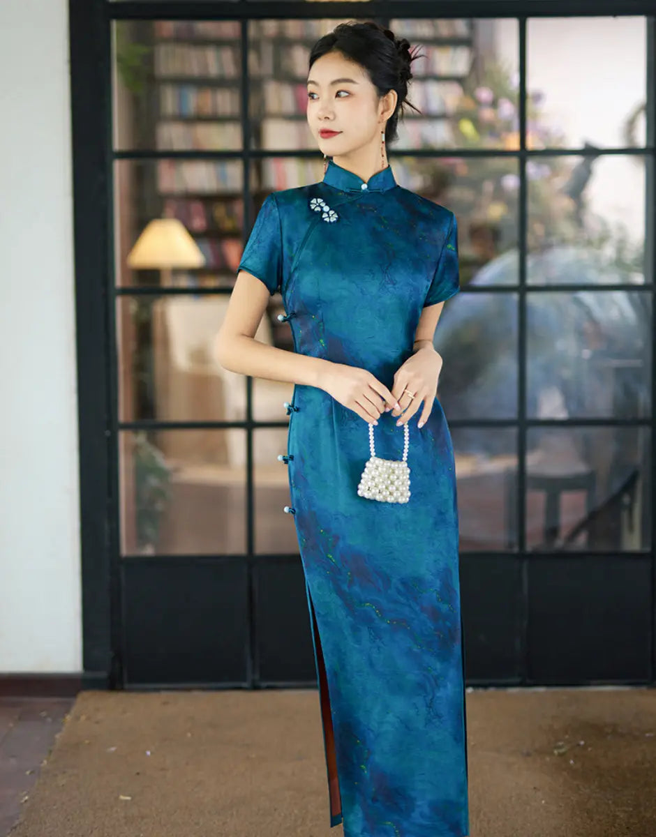 Woman in a Azure Blue Short Sleeve Acetate Satin Qipao Dress  holding a white handbag indoors.