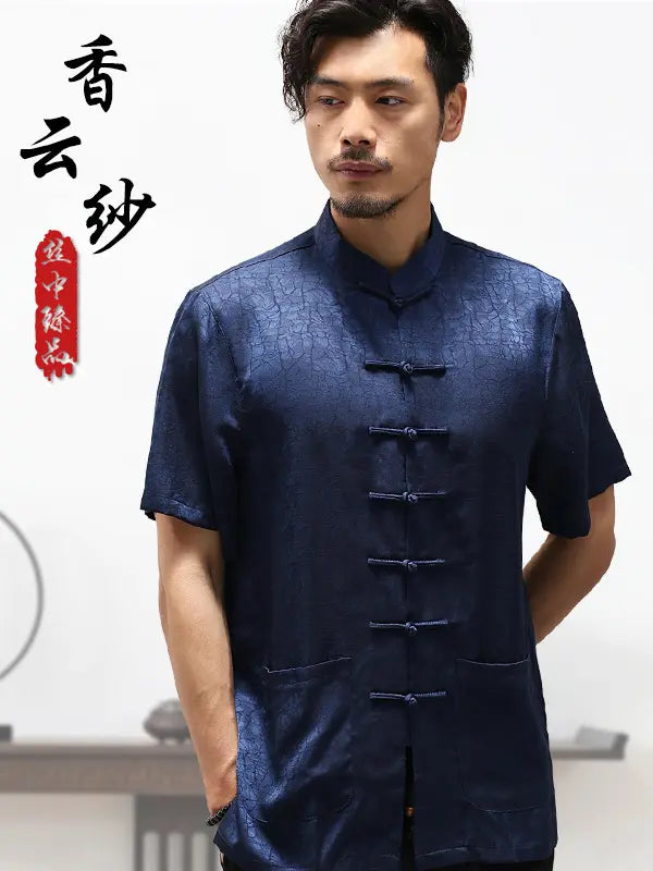 Man wearing a dark blue traditional Chinese Men's Luxury Mulberry Silk Jacquard Short Sleeve Tang Shirt garment with text on a white background