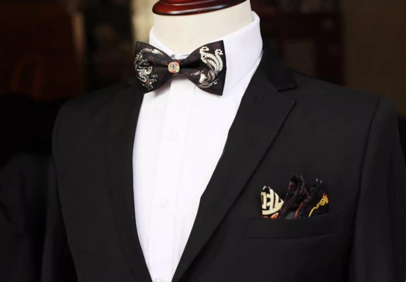 a Black bow tie with golden dragon and phoenix and golden double happiness at the centre for groom.