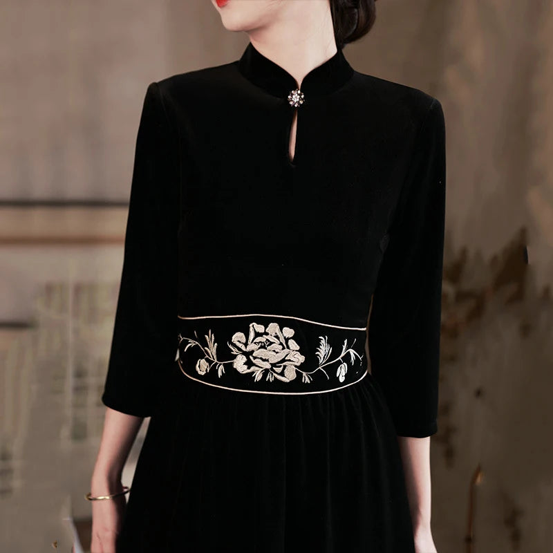  Black 3/4 Long Sleeves A Line Velvet Qipao Dress with   floral embroidery   on a blurred background