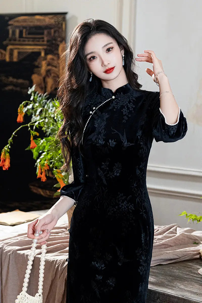 A chinese woman in Black 3/4 Long Sleeves Velvet Jacquard Qipao with Pearl Trim