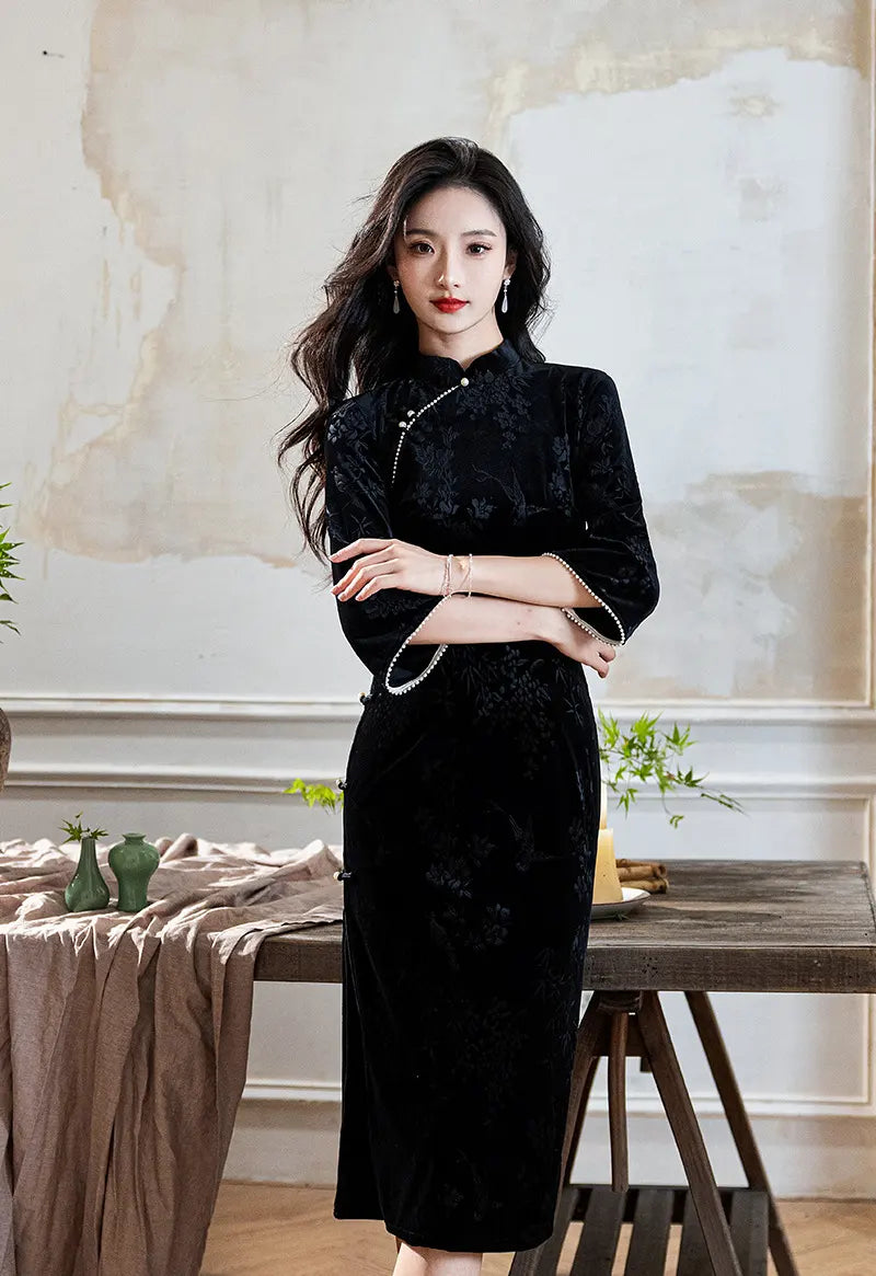 A chinese woman in Black 3/4 Long Sleeves Velvet Jacquard Qipao with Pearl Trim