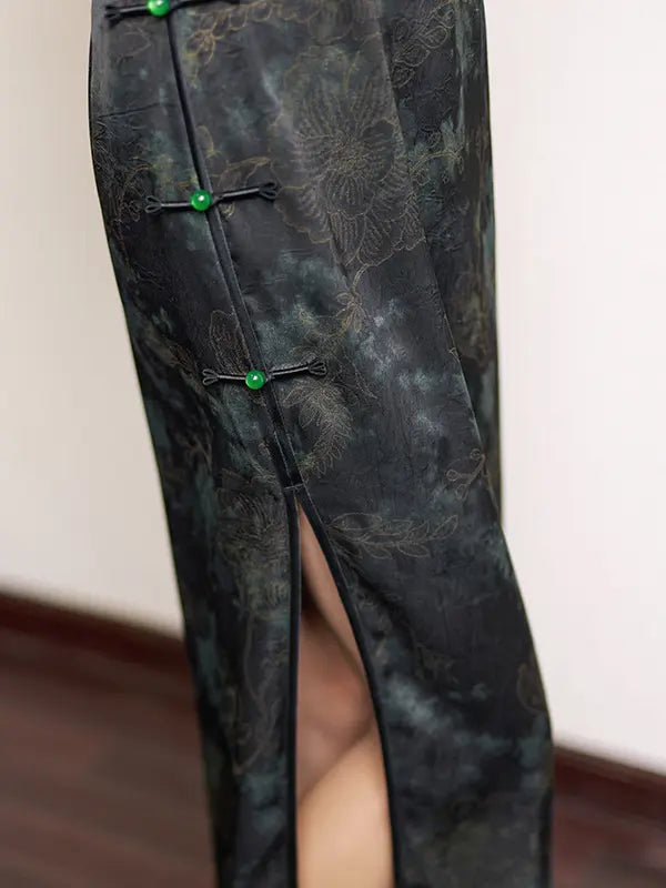 Dark green patterned qipao cheongsam dress with green buttons on a plain background