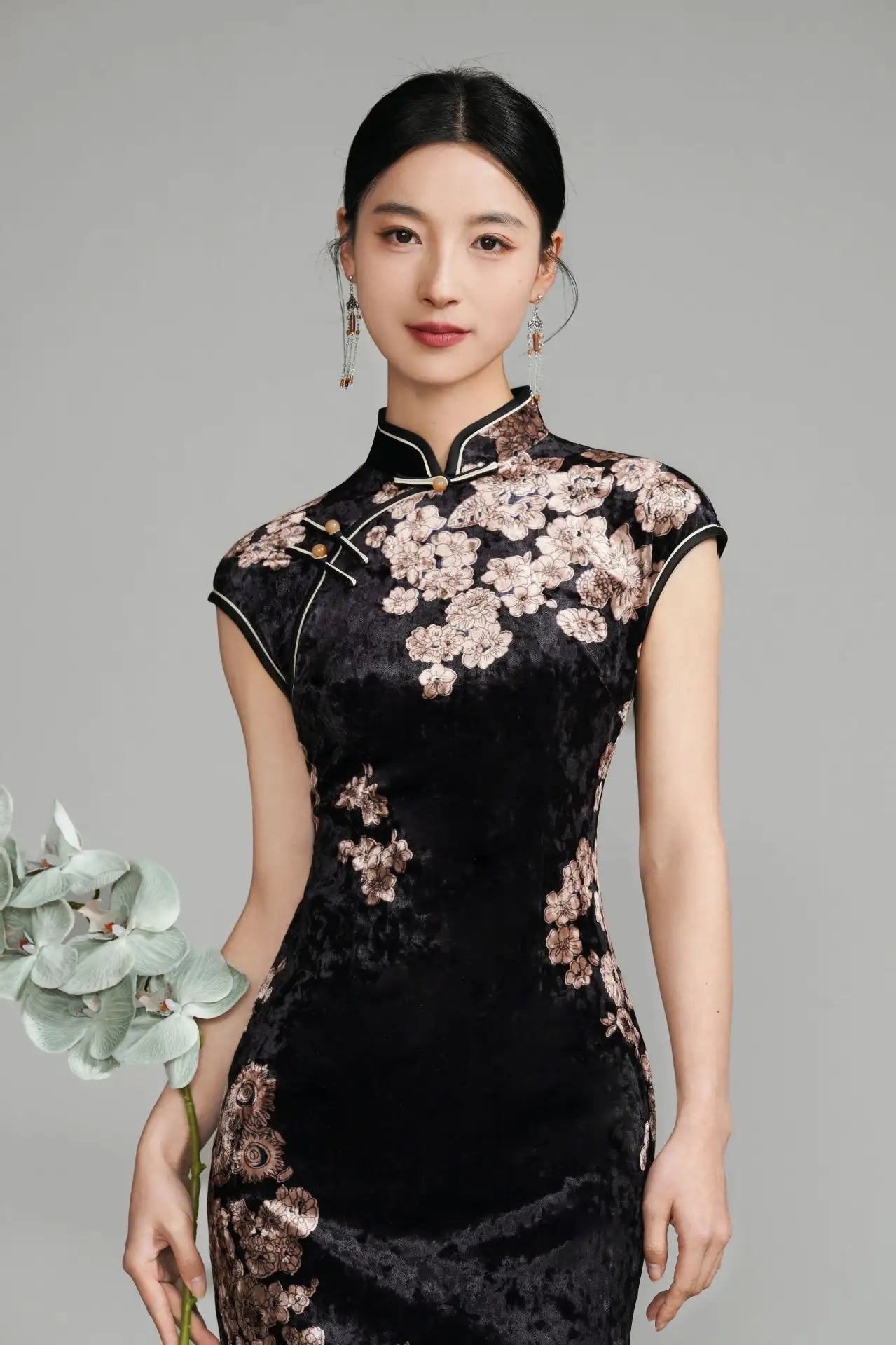 Woman wearing a Black Floral Velvet Long Qipao Cheongsam Dress against a gray background