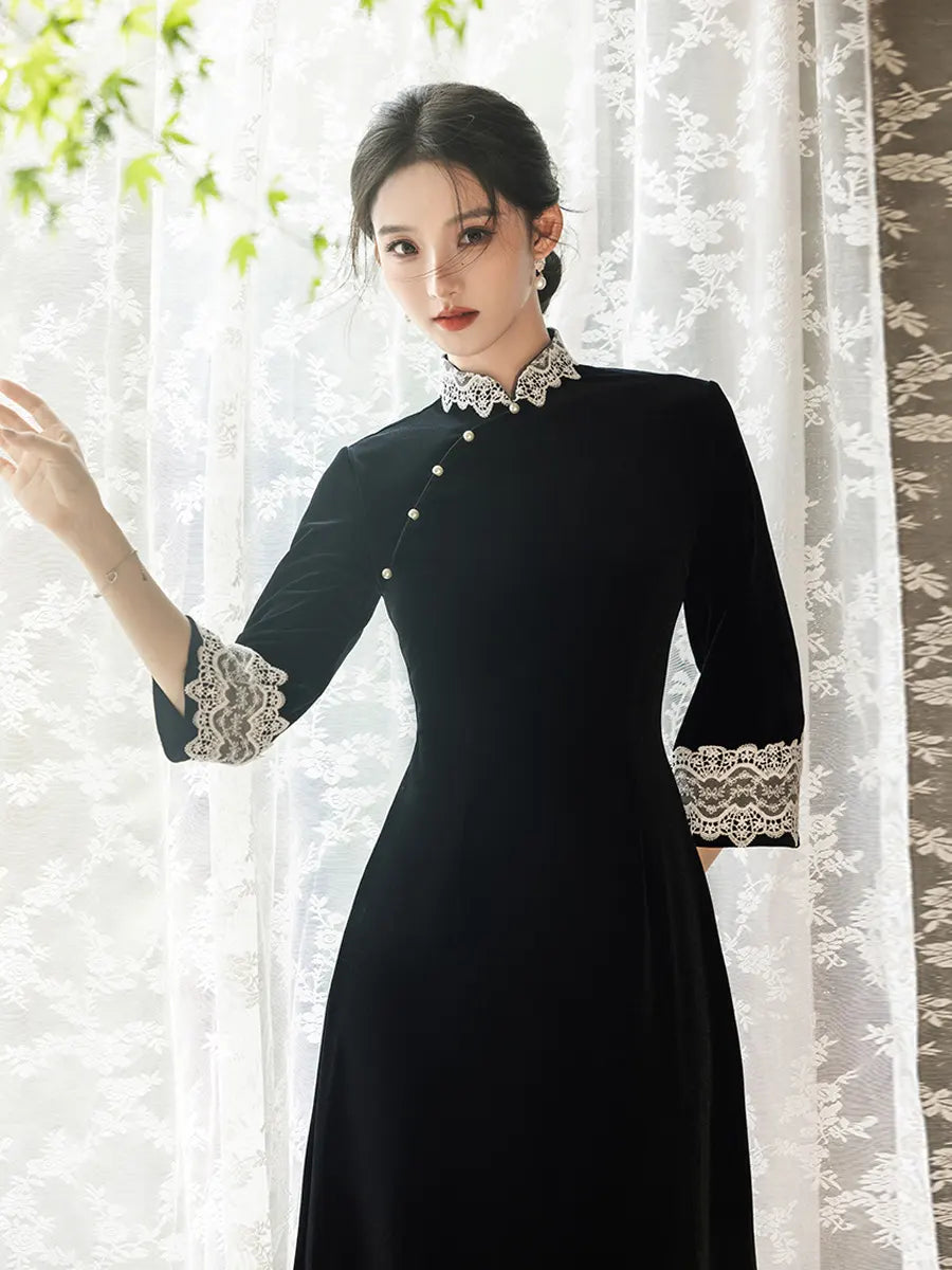 Woman wearing a Black Long Sleeves Velvet A-Line Qipao with Lace Trim  details in front of a white curtain.