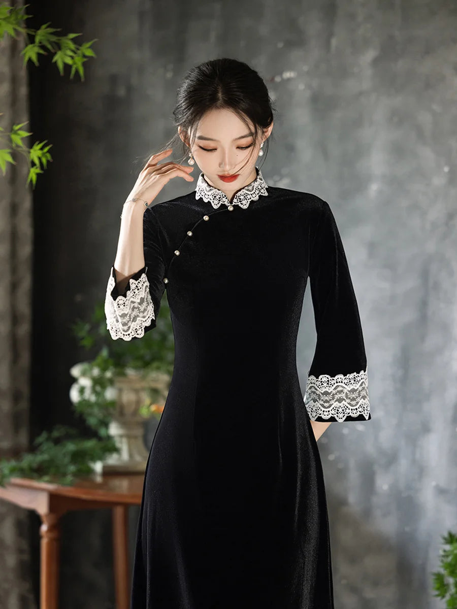 Woman wearing a Black Long Sleeves Velvet A-Line Cheongsam with Lace Trim  details against a gray background
