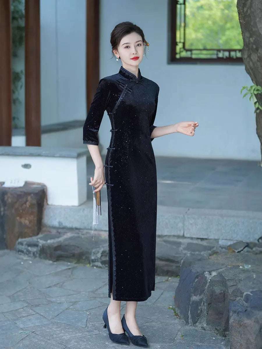 Woman in a Black Long Sleeves Velvet Chinese long cheongsam  Dress  standing outdoors with a traditional setting.