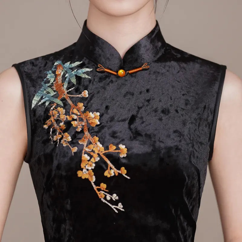 Black Modern Velvet Sleeveless Embroidered Qipao  with floral embroidery on a neutral background