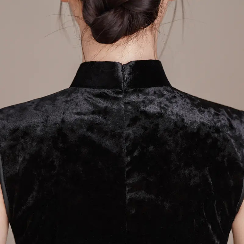 Black Modern Velvet Sleeveless Embroidered Qipao worn by a person with a neutral background
