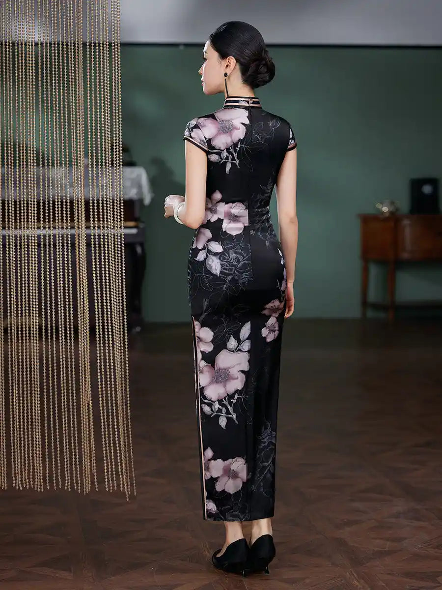Woman wearing a black floral dress in an indoor setting