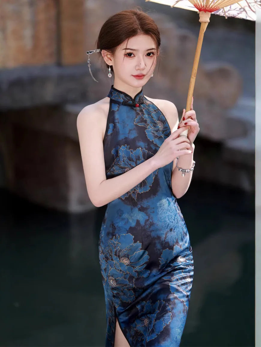 Woman in a Blue Floral Halter Qipao Cheongsam Dress  holding an umbrella with a blurred background