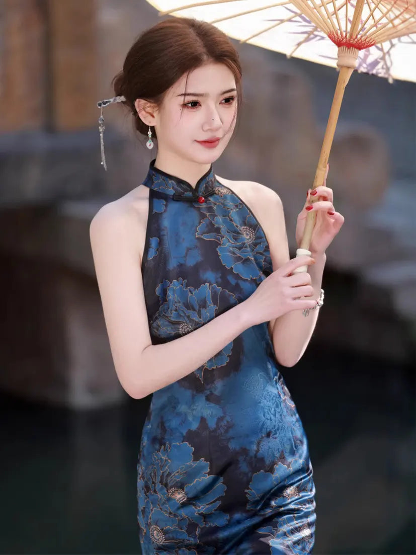 Woman in aBlue Floral Halter Qipao Cheongsam Dress  holding a traditional umbrella with a blurred background