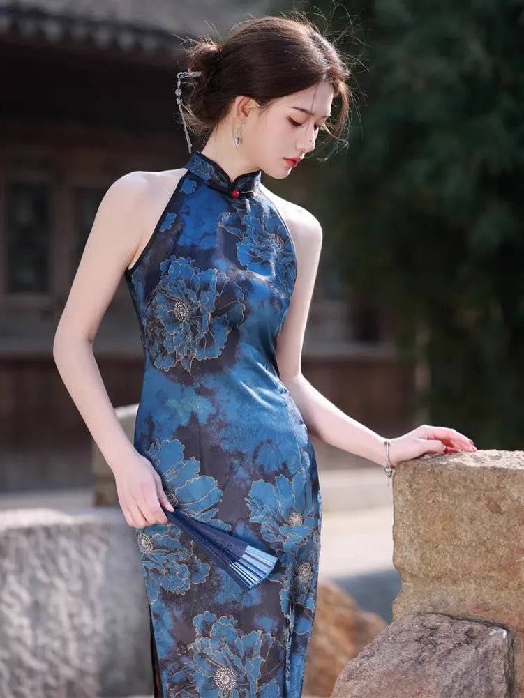 Woman in a Blue Floral Halter Qipao Cheongsam Dress  standing outdoors with a blurred background