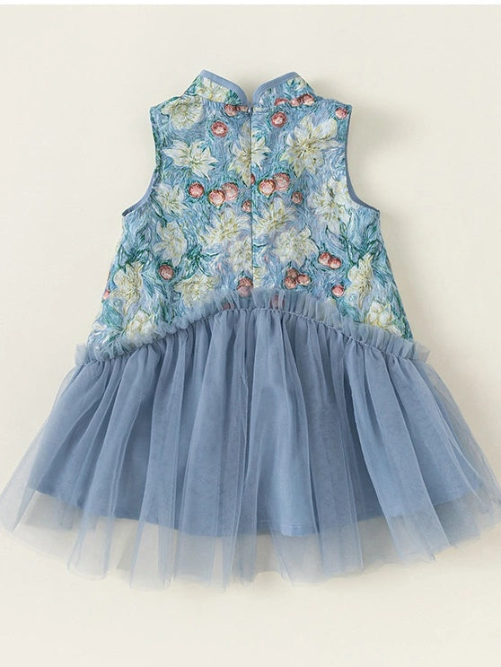 A Girls Traditional Chinese Floral Sleeveless Tulle Qipao  dress with a floral embroidered bodice in light blue, white, and pink, featuring a ruffled waist and a layered light blue tulle skirt, displayed flat against a light beige background.