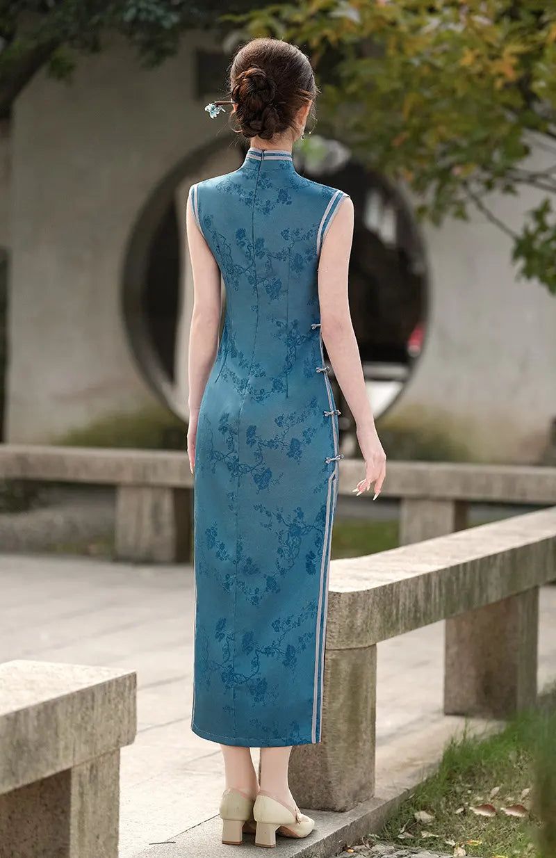 Woman in aBlue Jacquard Sleeveless Midi Qi pao Dress  standing outdoors with a blurred background