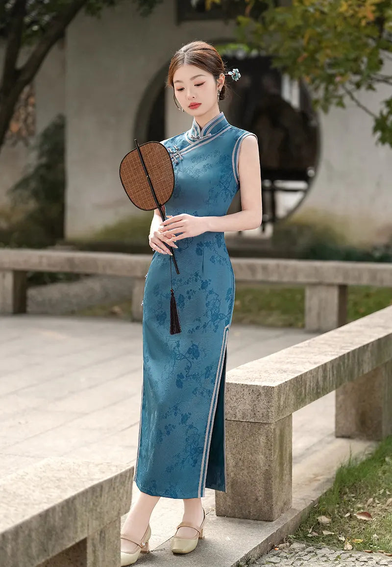 Woman in a Blue Jacquard Sleeveless Midi cheongsam Dress holding a fan outdoors.