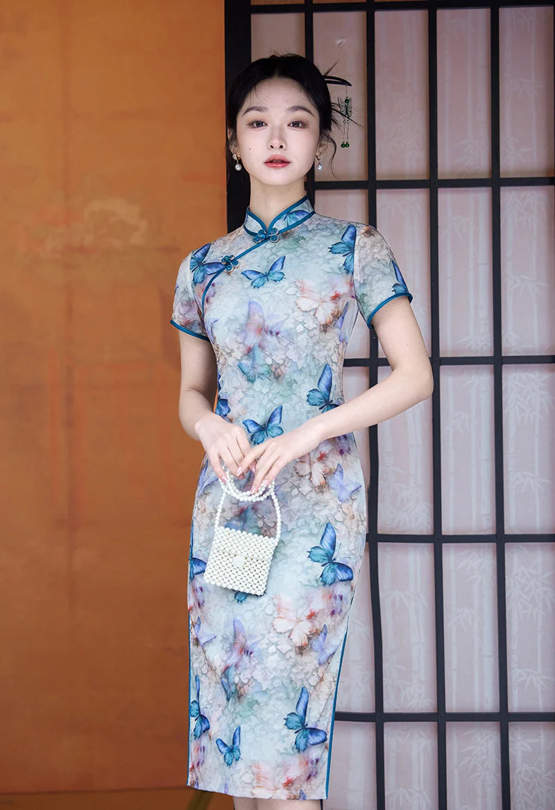 Woman wearing a Blue Midi Length Qipao Dress with Butterfly and Floral Print  with butterfly patterns in front of a traditional Japanese sliding door.
