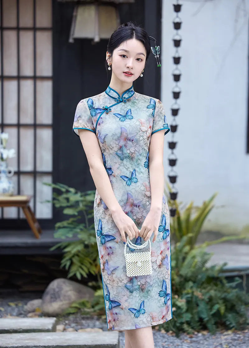 Woman wearing a Blue Midi Length Qipao cheongsam Dress with Butterfly and Floral Print  with butterfly patterns outdoors.