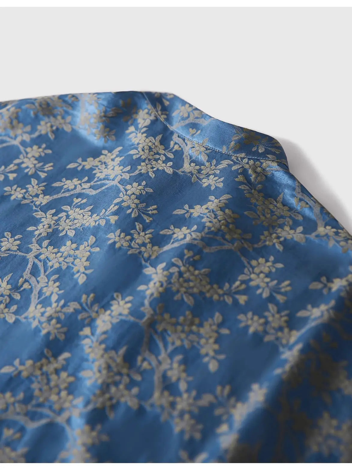 Blue fabric with white floral pattern on a white background