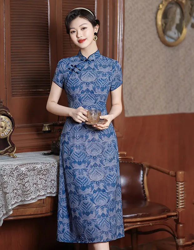 Woman in a Blue Short Sleeves patterned  A-Line Qipao Dress  holding a glass in an elegant room.