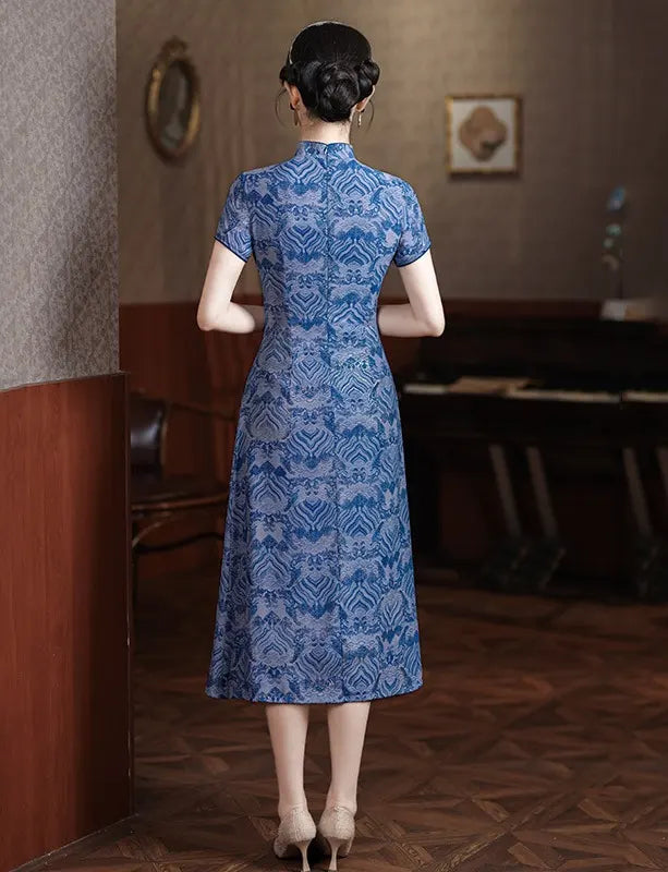 Woman wearing a Blue Short Sleeves patterned  A-Line Qipao Dress  standing in a room with wooden paneling.