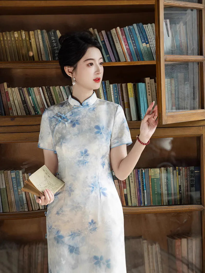 Woman in a Blue Watercolor Floral Long Qipao Cheongsam Dress  standing in front of a bookshelf
