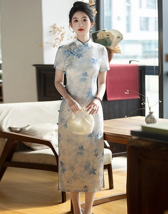 Woman in aBlue Watercolor Floral Long Qipao Cheongsam Dress  standing in a room with furniture and decor.