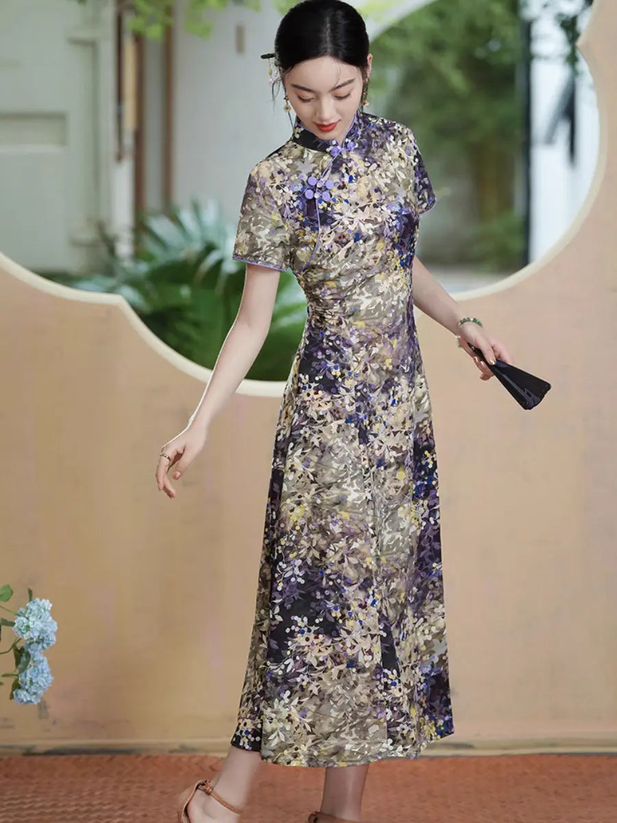 A woman wearing a short-sleeved, Botanical Violet & Olive Floral Jacquard Modern A Line Qipao  cheongsam dress with a dense floral print in purple, gold, and beige, holding a black clutch in a styled indoor-outdoor setting.