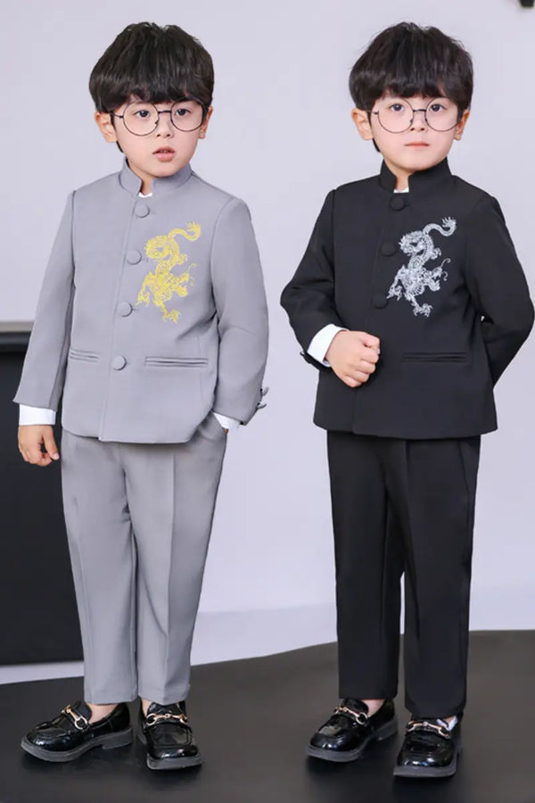Two children wearing formal Boys' New Chinese Style Dragon Embroidered Zhongshan Suit Set with embroidered designs on a plain background