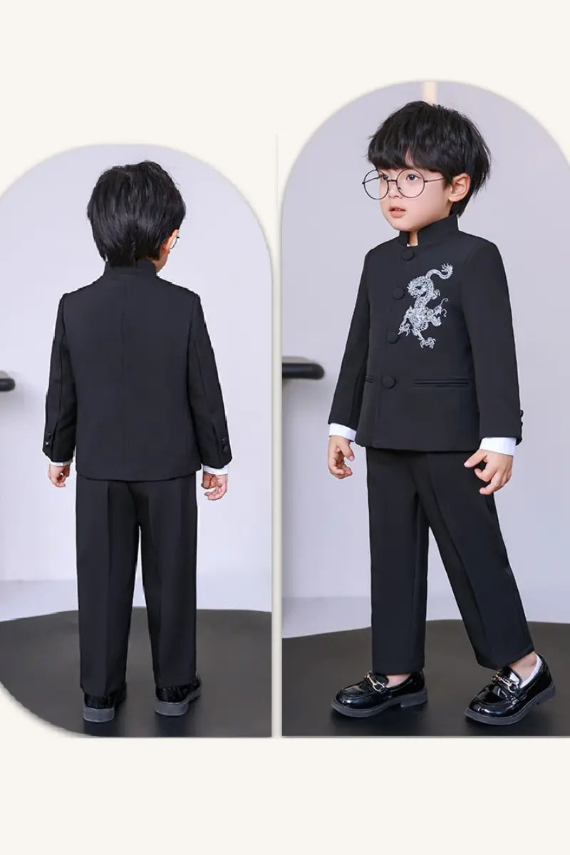 Child wearing a blackBoys' New Chinese Style Dragon Embroidered Zhongshan Suit Set  in front of a mirror.