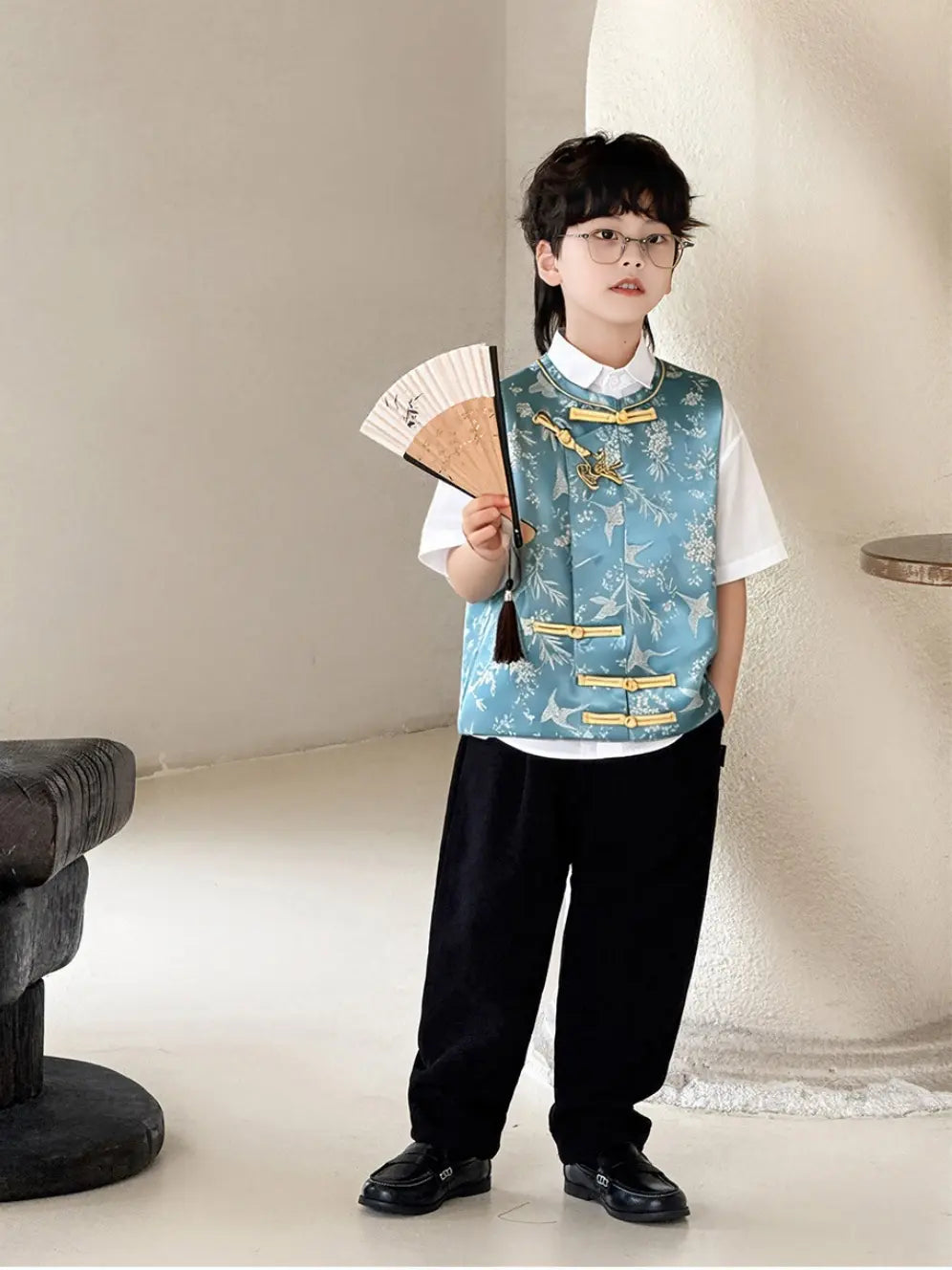 Child wearing a Boys' Traditional Chinese Style Blue Vest Outfit  and holding a fan indoors.