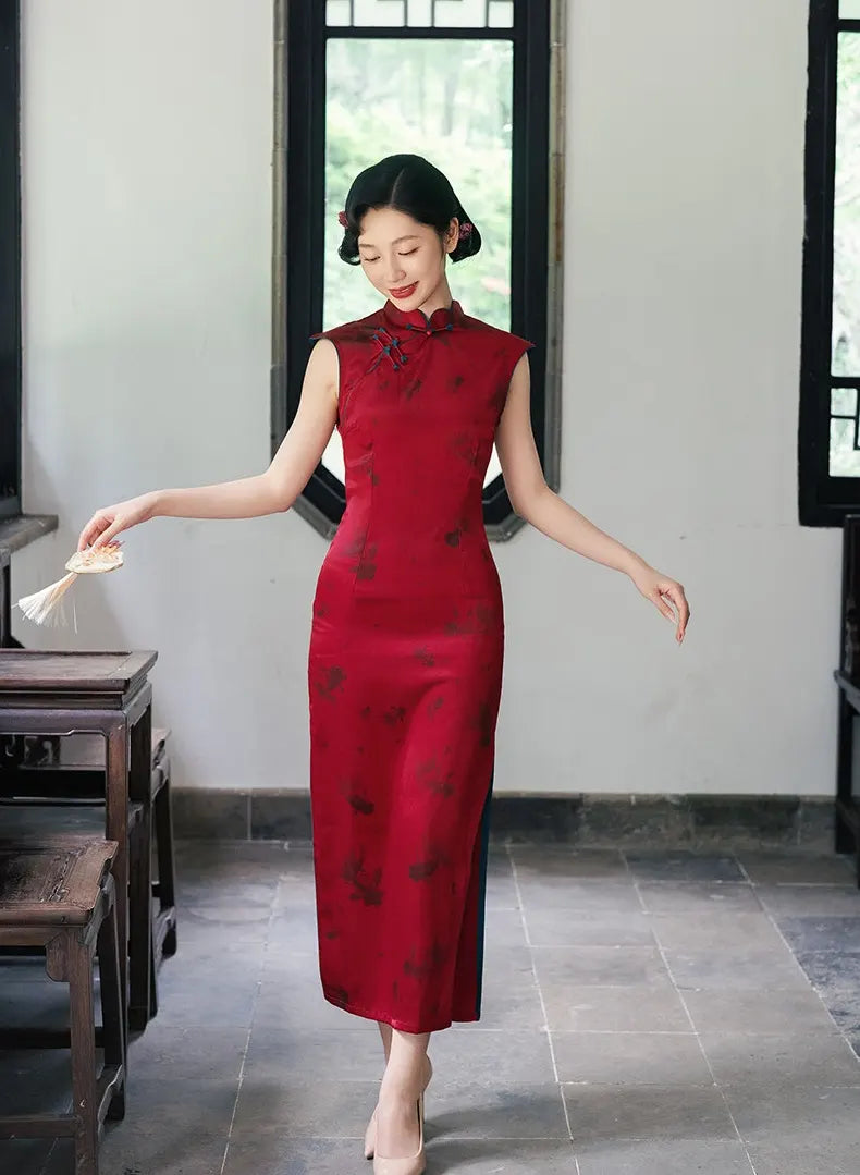 Woman in a Crimson Red Sleeveless Goldfish Qipao Dress  standing in a room with large windows.