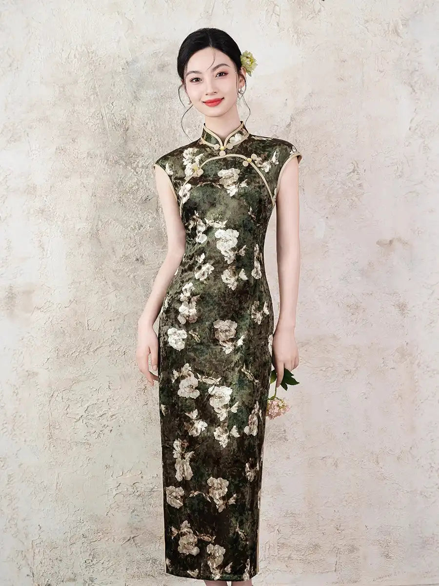 Woman wearing aDark Green Foral Velvet Cap Sleeves Long Chinese Qipao Dress  against a textured wall