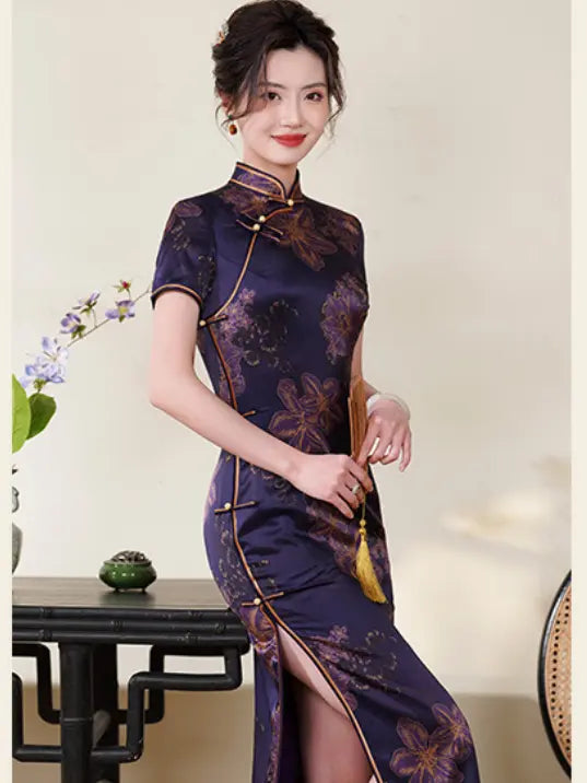 Woman wearing a traditional  Deep Amethyst Purple & Gold Floral Silk Long Qipao cheongsam dress with floral patterns in an indoor setting.