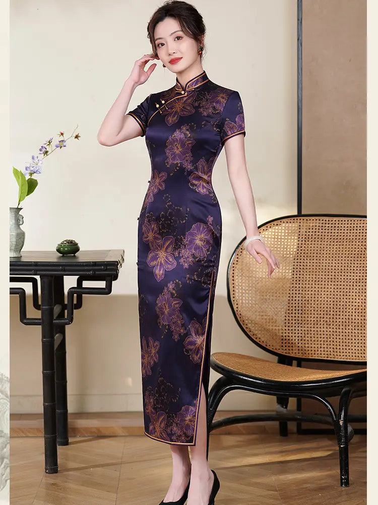 Woman wearing a Deep Amethyst Purple & Gold Floral Silk Long Qipao  dress in an elegant room with a table and chair.