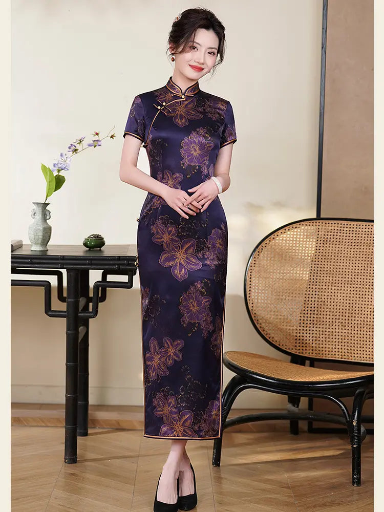 Woman wearing a Deep Amethyst Purple & Gold Floral Silk Long Qipao  dress in an elegant room with a table and chair.