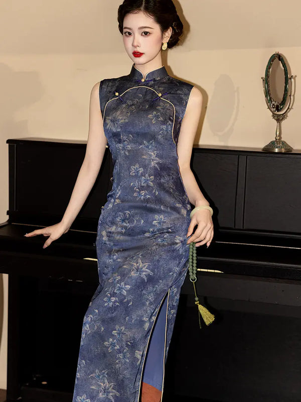 A woman wearing a sleeveless blue floral cheongsam qipao dress with gold trim, posing in front of a black piano.