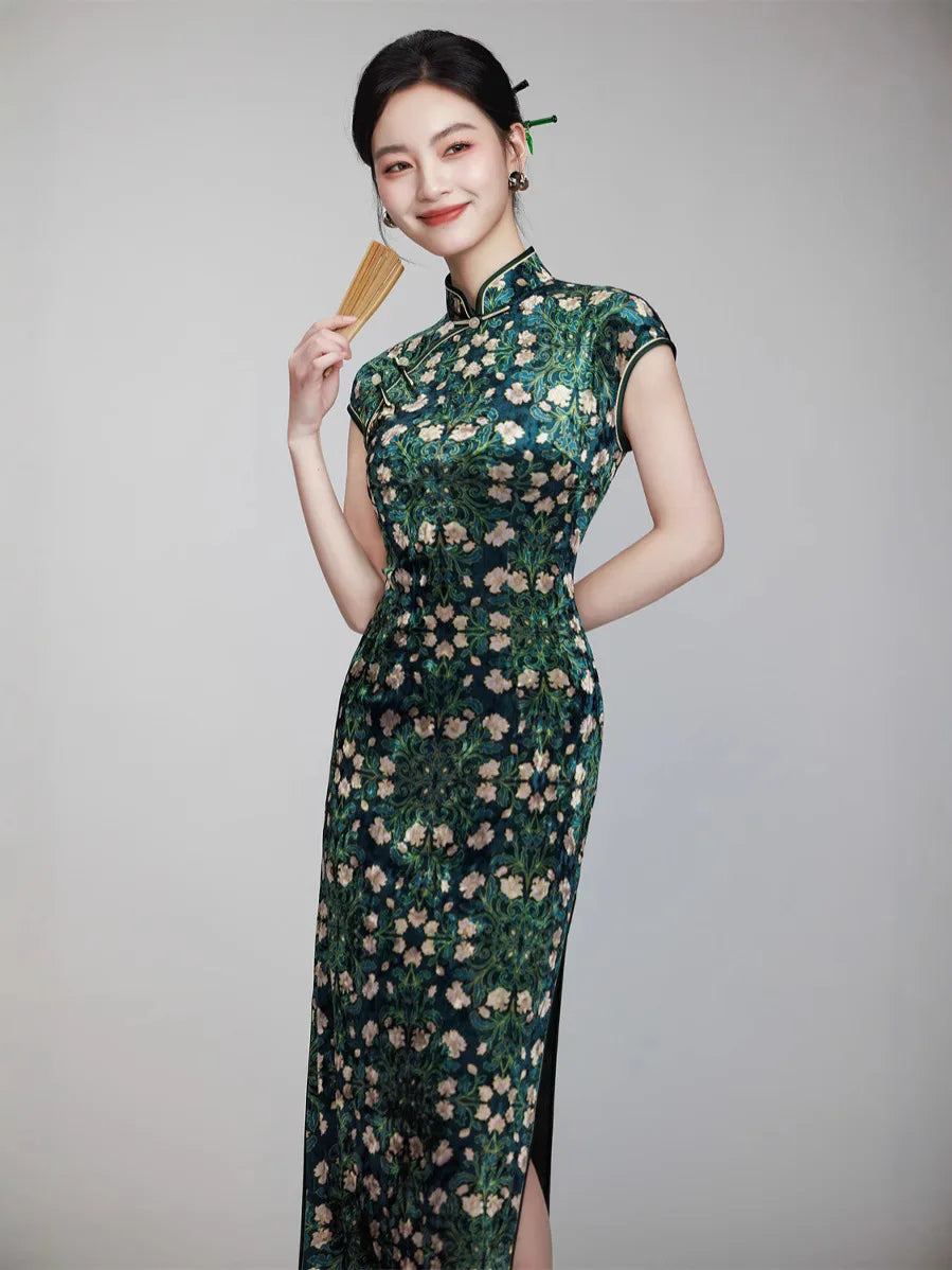 Woman wearing a Deep Green Floral Cap Sleeves Long Qipao Dress against a gray background