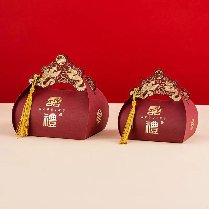 Two red Dragon & Phoenix Double Happiness Chinese Wedding Favor Boxes  gift boxes with gold tassels on a red background
