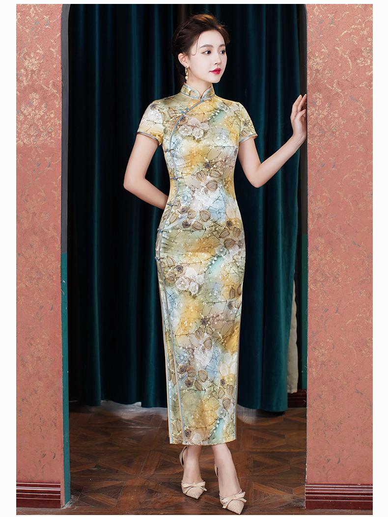 Woman wearing a Elegant Floral Mulberry Silk Qipao Cheongsam Dress  standing in front of a green curtain.