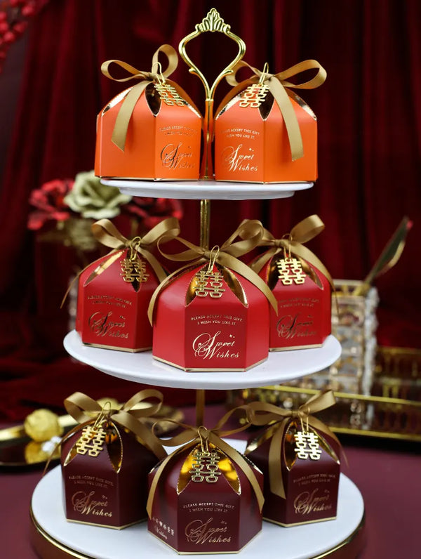 Three-tiered stand with red and gold Elegant chinese Wedding Favor Boxes with Double Happiness Charm  labeled 'Wishes' against a red background